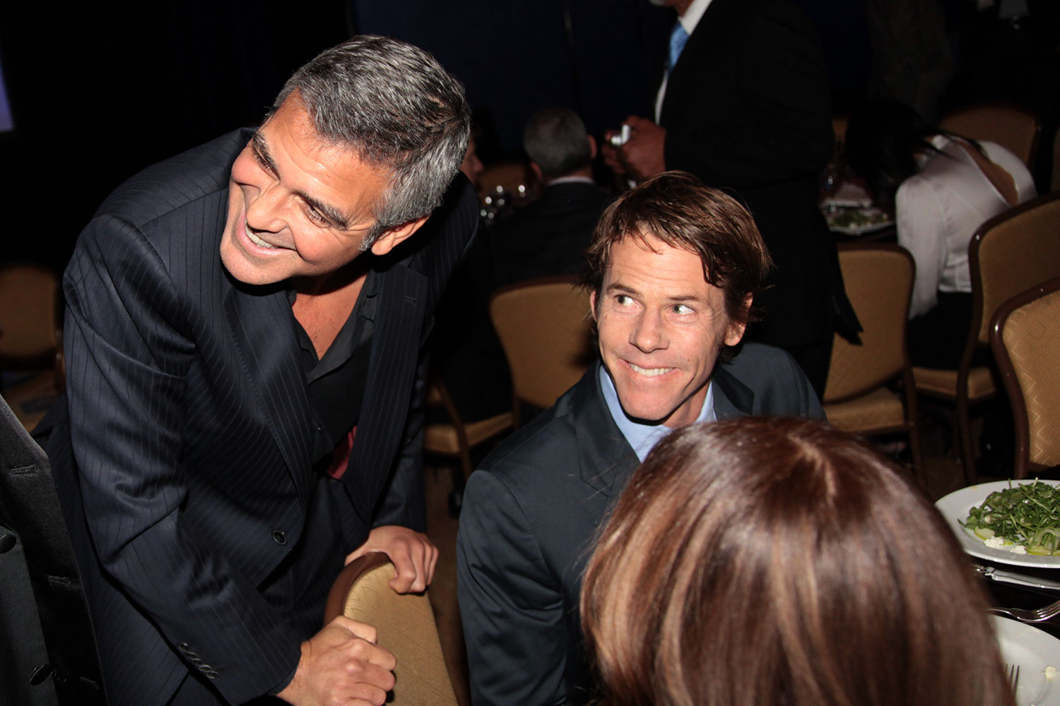 Candid event interaction at charity gala